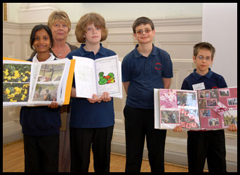 Teacher and 4 pupils displaying their work