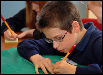 Young boy writing at a desk